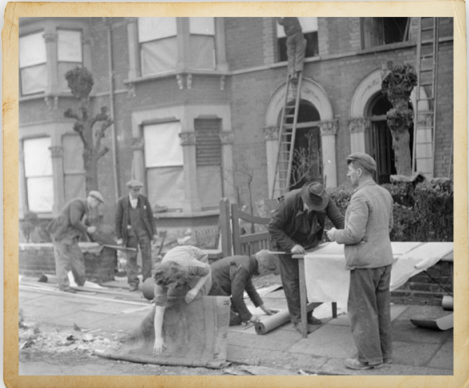 Black and white image. Post war repairing bomb damaged housing.