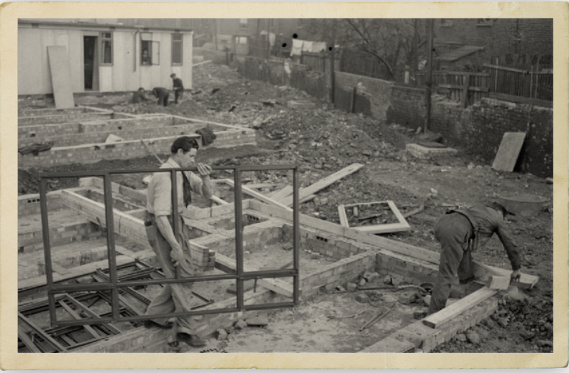 Men working in a prefab housing, post-war.